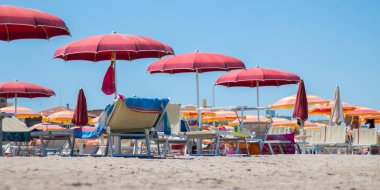 Sahilde şemsiyeler ve güneş yatakları.