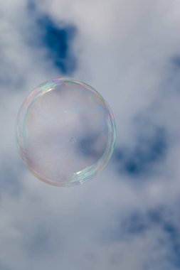 Colored soap bubble flying in a blue sky
