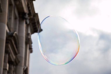 Colored soap bubble flying in town