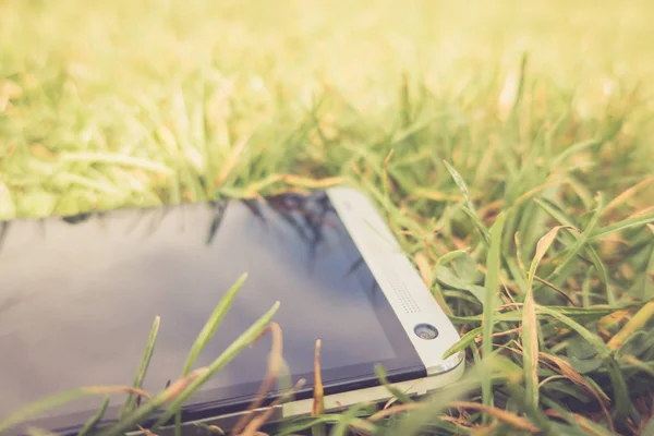 close up of phone in green grass