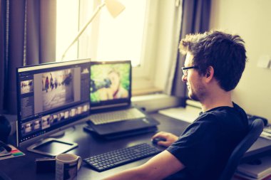 Bilgisayarda çalışan genç adamın portresi