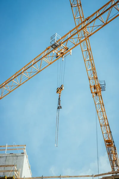 Closeup of a tower crane in a construction yard