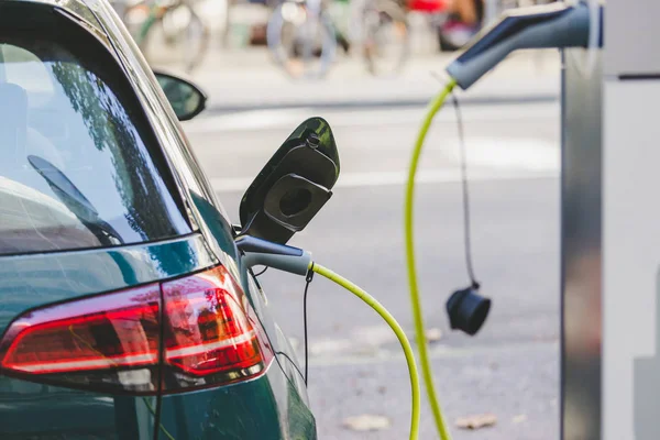 Electric car recharging with charge cable and plug leading to charge point