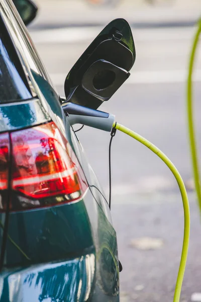 Electric car recharging with charge cable and plug leading to charge point