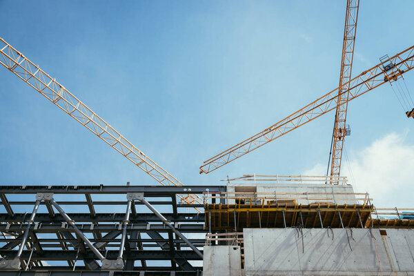 Construction site with cranes and blue sky