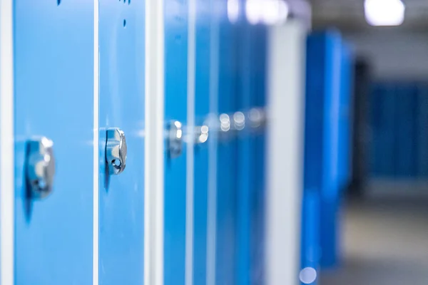 Blue cage lockers in a gym