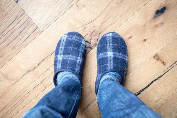 Man feet at home in winter slippers