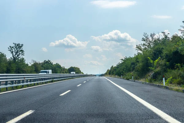 asphalt road in the mountains and blue sky