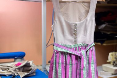 Dirndl dress in a dressmakers workshop clipart