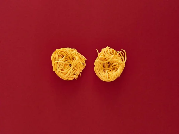 Italian noodle pasta uncooked over wine background in studio from top view — Stock Photo, Image