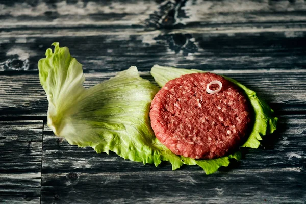 hamburger meat  in a green lettuce viewed from above