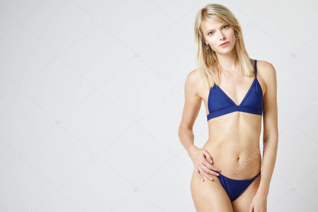 Girl in bikini isolated in studio with a white background