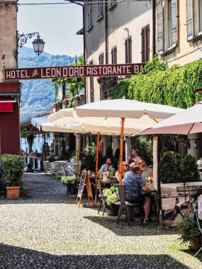 Resturants in Orta San Giulio town Italy with tourist  clipart
