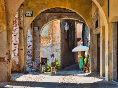 Orta San Giulio Arch alley Lake Orta İtalya'da di de giysi ile