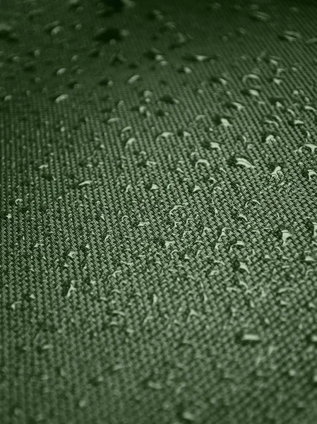 Water drops on the fabric texture. wet textile texture. cloth with water drops. moist fabric pattern.