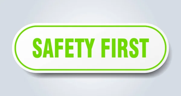 Sicherheit erstes Zeichen. Sicherheit erste runde grüne Plakette. Sicherheit geht vor — Stockvektor