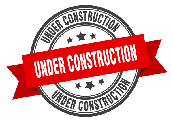 Under construction label. under construction red band sign. under construction — Stock Vector