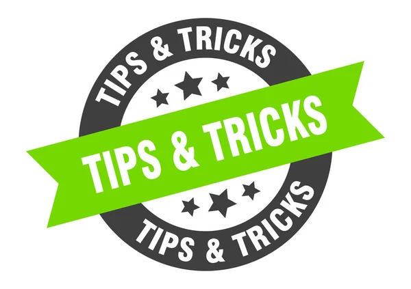 Tips & tricks sign. tips & tricks black-green round ribbon sticker — ストックベクタ