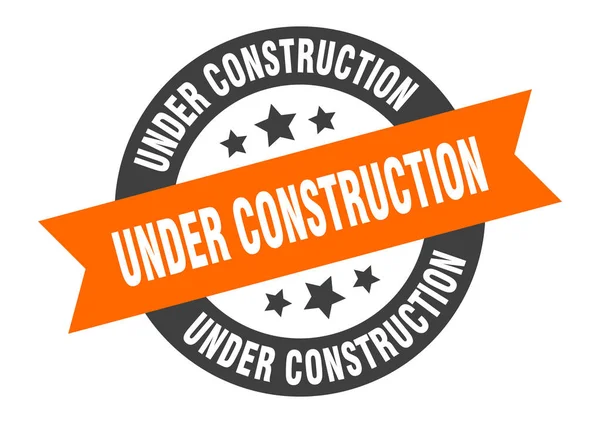 Under construction sign. under construction orange-black round ribbon sticker — Stock Vector