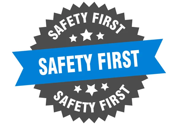 Első biztonsági jel. biztonság első kék-fekete kör alakú szalag címke — Stock Vector