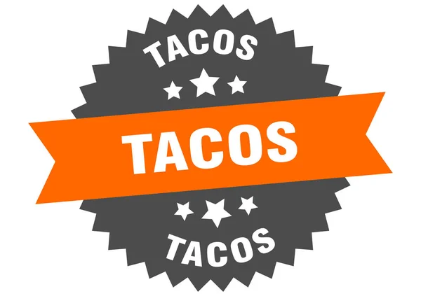 Znamení tacos. tacos oranžovo-černý kruhový štítek — Stockový vektor