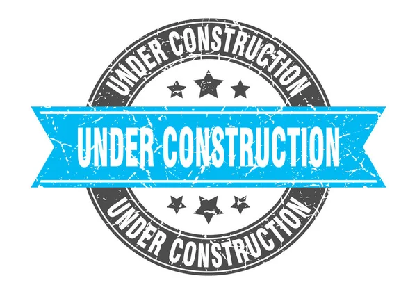 Under construction round stamp with turquoise ribbon. under construction — Stock Vector
