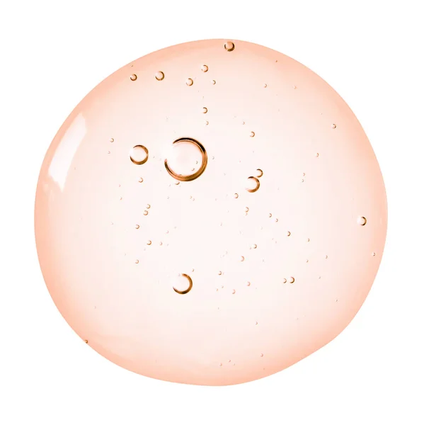 Serum dokusu. Beyaz arka plan üzerinde izole kabarcıklar swatch ile Turuncu pembe berrak sıvı jel.