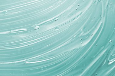 Serum, sıvı jel dokusu. Temiz bir kozmetik krem geçmişi. Transpatent rengarenk cilt ürünü lekesi