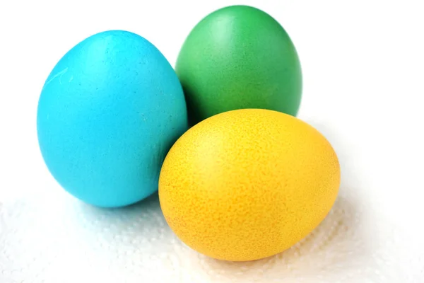 Green, blue and yellow egg. Easter eggs on a white background. Stock Picture