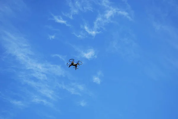 Drone in flight against the sky, new technologies in aerial photography.