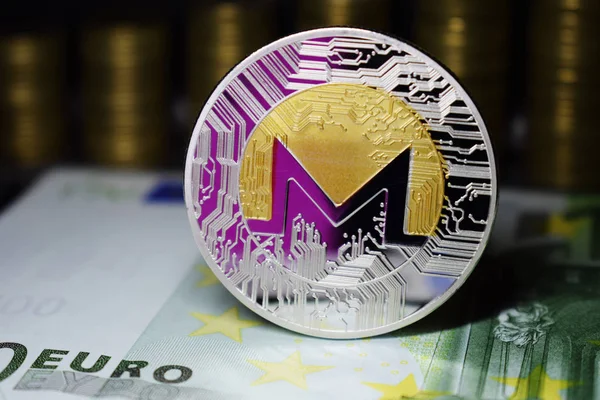 Coin physical Monero XMR with a pink shade.
