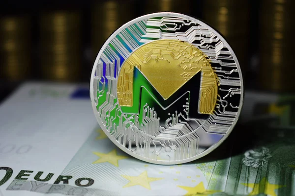 Coin physical Monero XMR with a green tint.