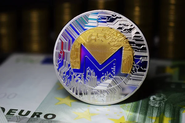 Coin physical Monero XMR with a blue tint.