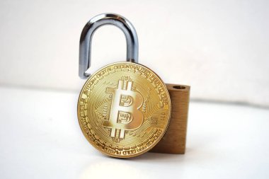 Bitcoin security concept. Gold coin with padlock. clipart