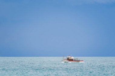 Boat on the Tyrrhenian Sea seen from the Minori and Maiori Beach, Amalfi Coast, Campania, Italy clipart