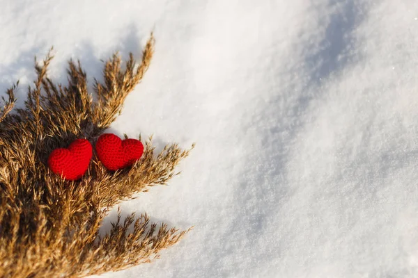 Red Knitted Hearts for Valentine\'s Day on the snow