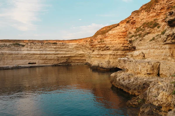 Puesta de sol en las rocas en el mar — Foto de Stock