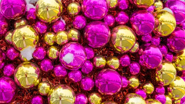 Christmas balls of gold and pink color. Festive background