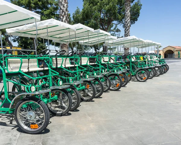 Four-wheeled bicycles in parking lot