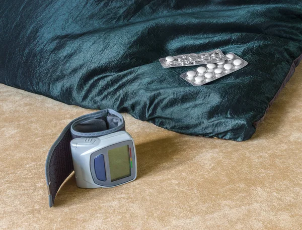 Wrist Blood Pressure Monitor Pills Lying Couch Soft Pillow — Stock Photo, Image