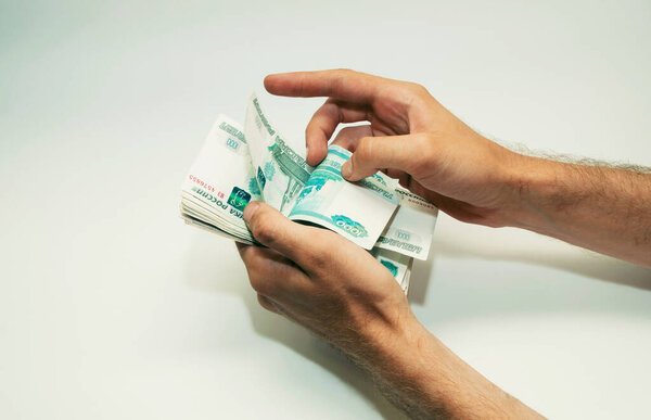 man in hands counts Russian paper money notes