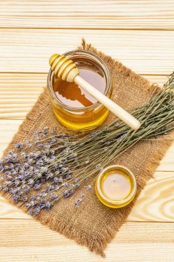 Cam kavanozlarda taze sıvı bal ve ahşap bal kaplaması.