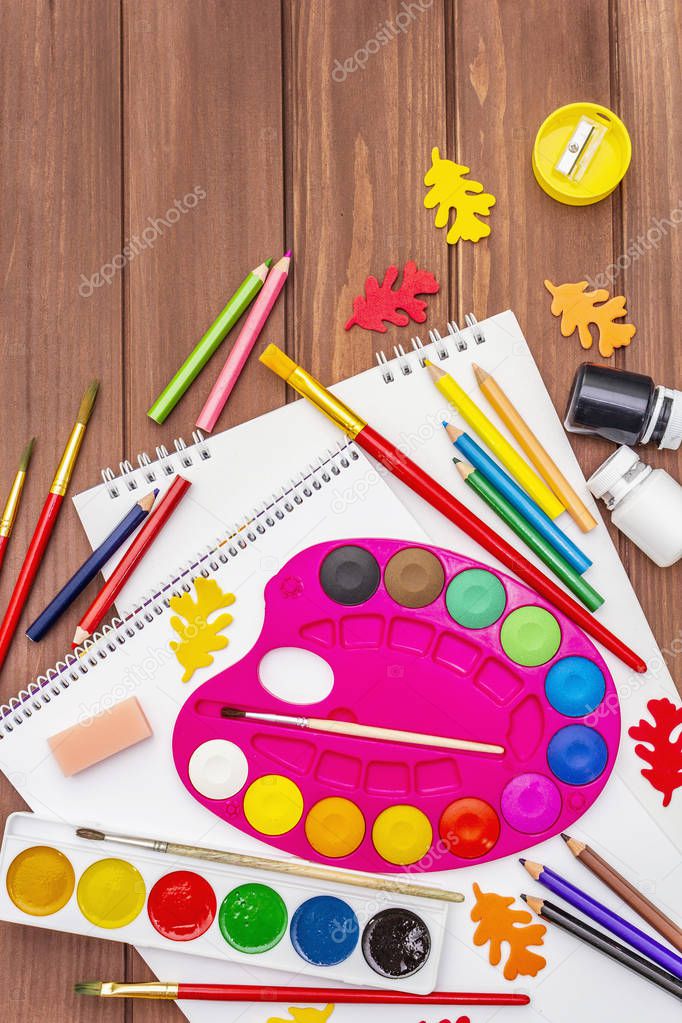 Back to school concept. School education supplies on brown wooden boards background