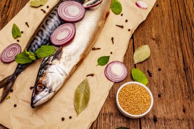 Uskumru turşusu. Geleneksel Norveç baharatlı tuzlu balığı. Baharatlar, Dijon hardalı, soğan. Eski tahta arka plan, üst görünüm