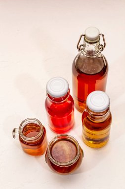 Cam şişelerde kombu çayı. Farklı tatlar seti. Sağlıklı mayalanmış yiyecek, iyi dengeli sindirim sistemi için probiyotik beslenme içeceği. Beyaz macun arkaplan, üst görünüm