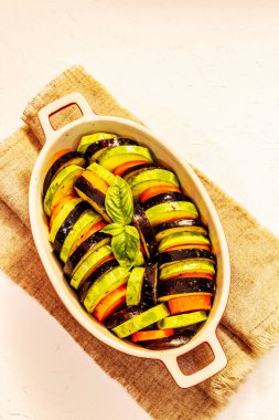 Pişirmek için taze sebzeler. Zeytinyağı, patlıcan, kabak, havuç, baharat ve fesleğen. Beyaz macun arkaplan, üst görünüm