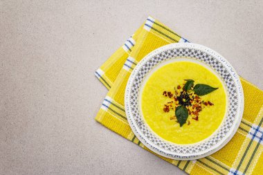 Taze sebzeli, otlu ve baharatlı mısır kremalı çorba. Klasik sonbahar yemeği, taş beton arka plan, üst görünüm.