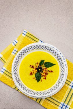 Taze sebzeli, otlu ve baharatlı mısır kremalı çorba. Klasik sonbahar yemeği, taş beton arka plan, üst görünüm.