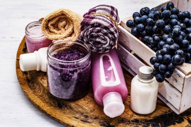 Olgun üzümlü doğal spa aksesuarları. Sağlıklı ve güzel kişisel bakım için taze malzemeler. Beyaz tahta arka plan, kapat