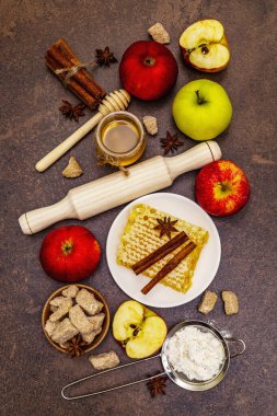 Elmalı turta pişirme konsepti. Olgun elmalar, taze bal ve sağlıklı malzemeler. Taş beton arka plan